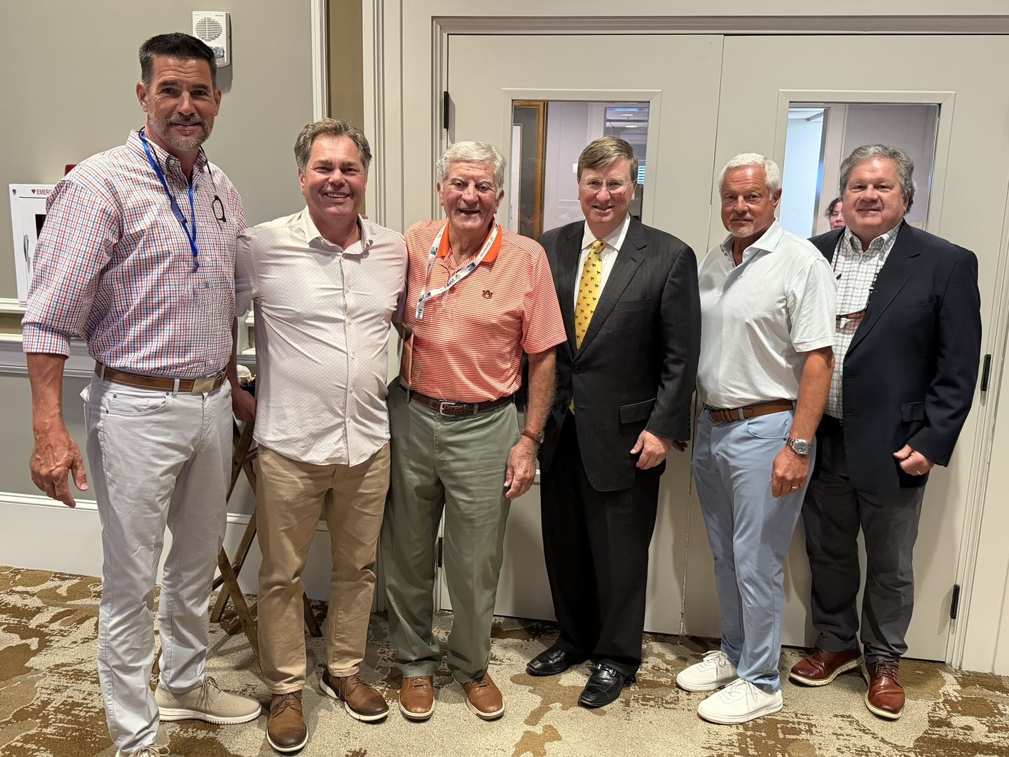 Six attendees pose together.