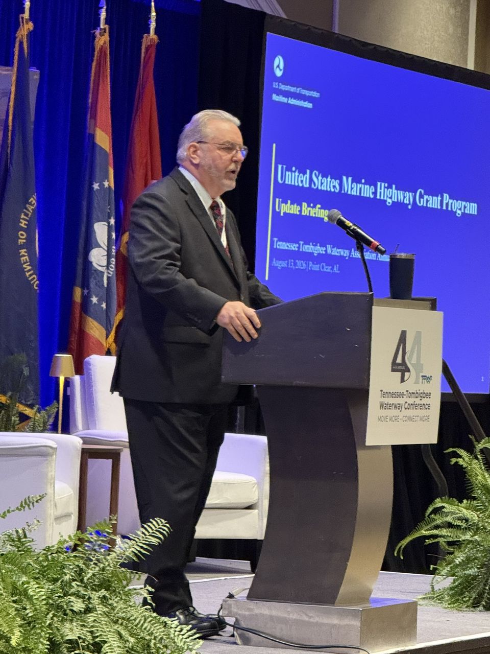 A speaker at the podium in front of a slide titled United States Marine Highway Grant Program.