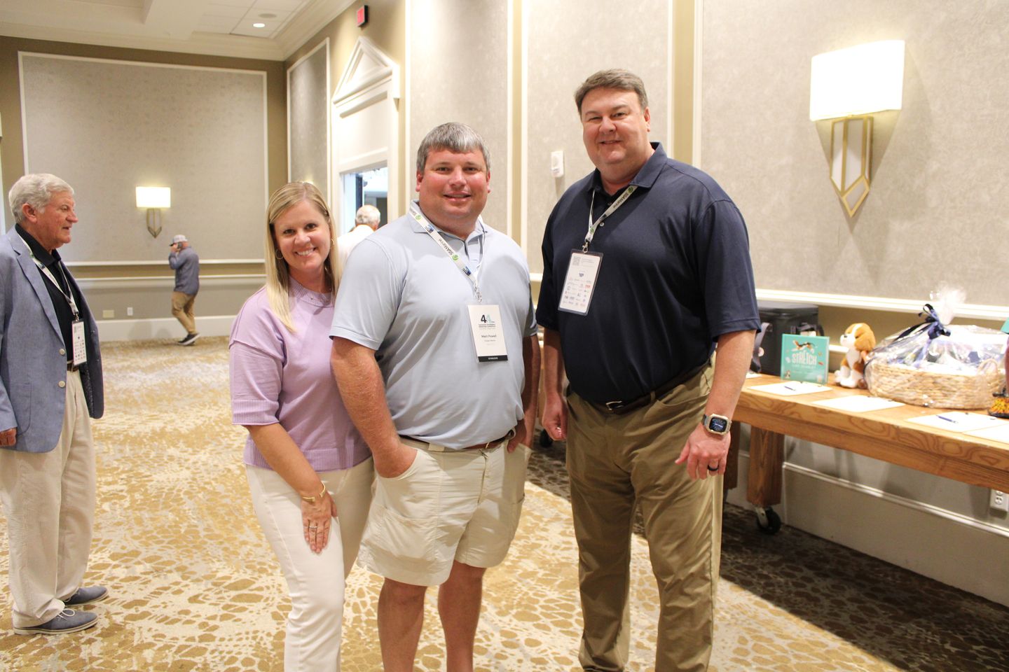 Four attendees pose at the reception.