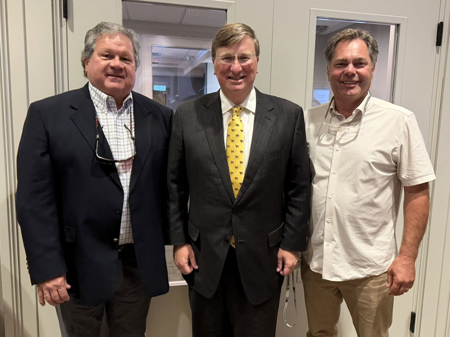 Three attendees pose together.