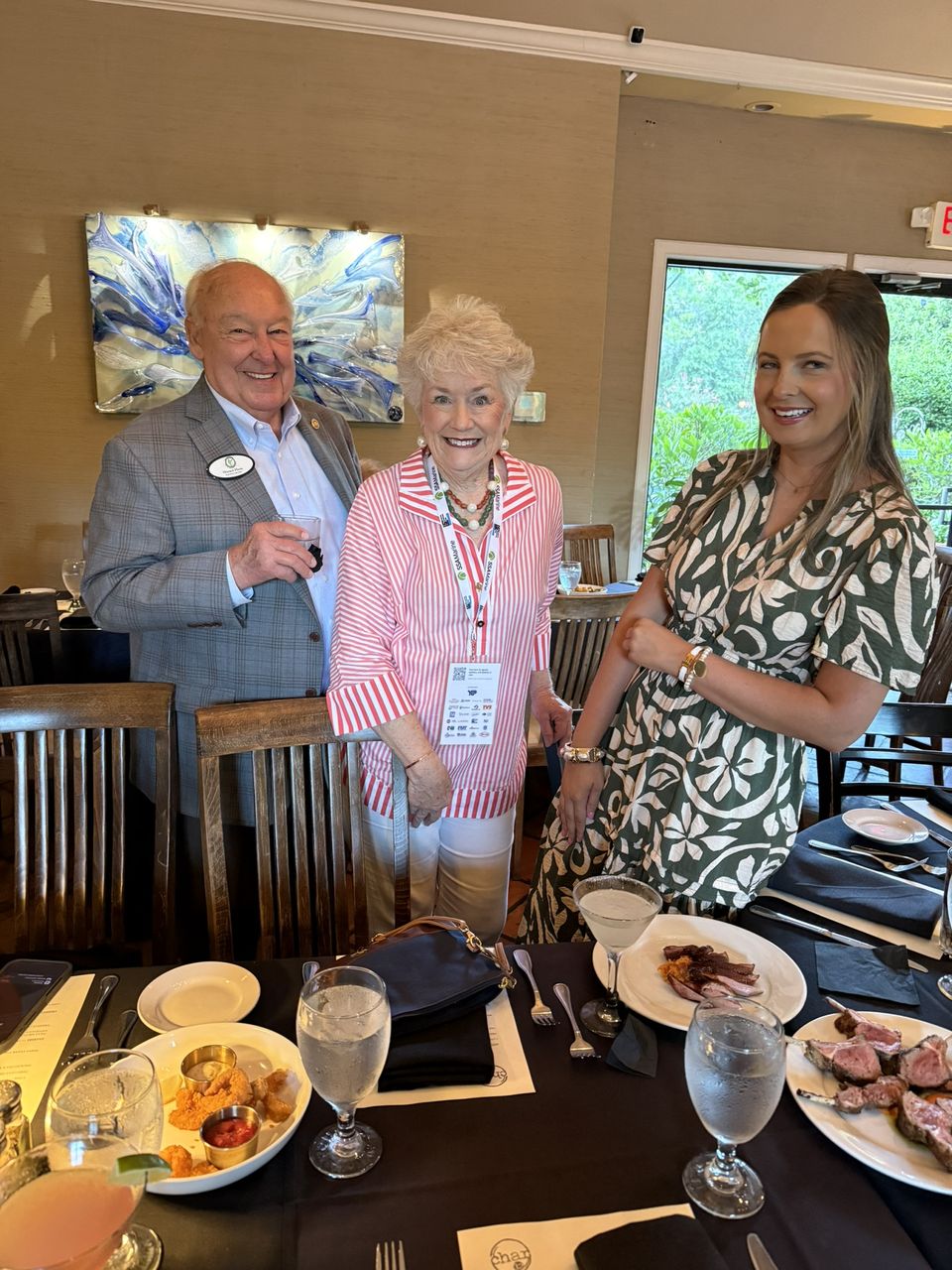 Three attendees at a dinner table.