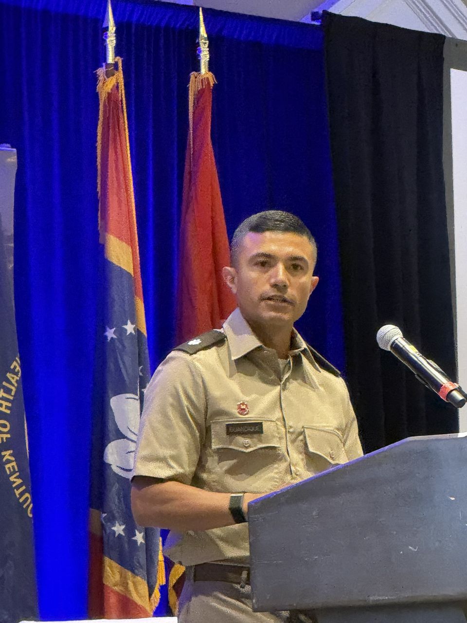 An Army officer speaks at the podium.