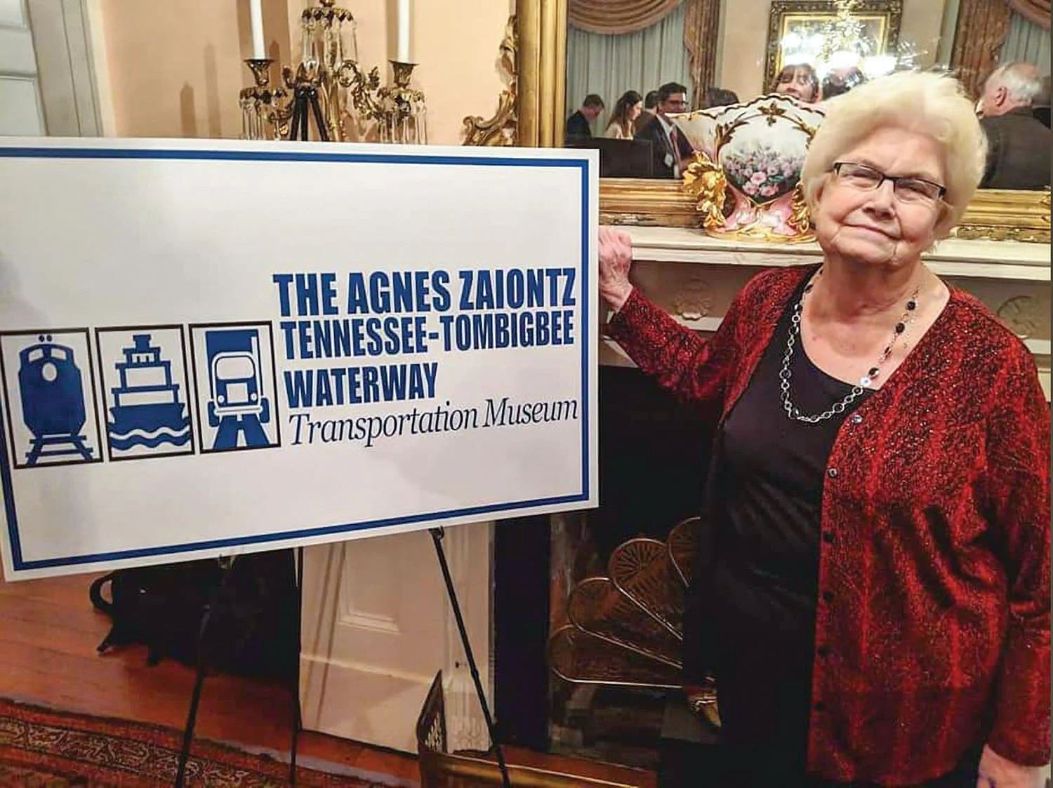 Agnes Zaiontz beside the museum sign