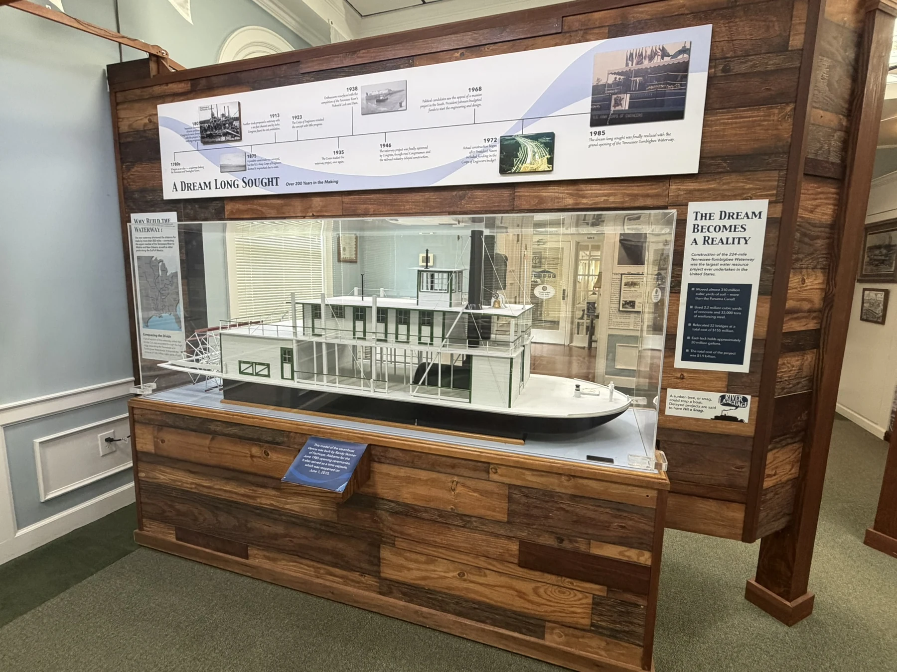 The detailed white and green steamboat Vienna model in its museum display case