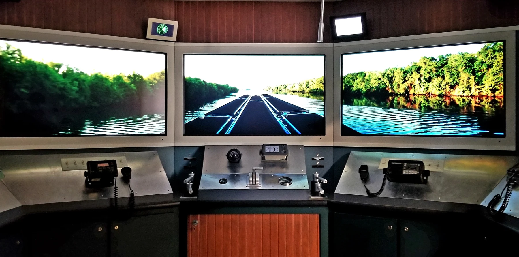 Actual museum pilot-house exhibit, with three river-view screens and controls